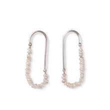 Load image into Gallery viewer, Silver pearl earrings laying flat on white surface. The earrings are made from silver canes with small hoops on both ends of each cane to attach a string of tiny pearls in a loose loop.